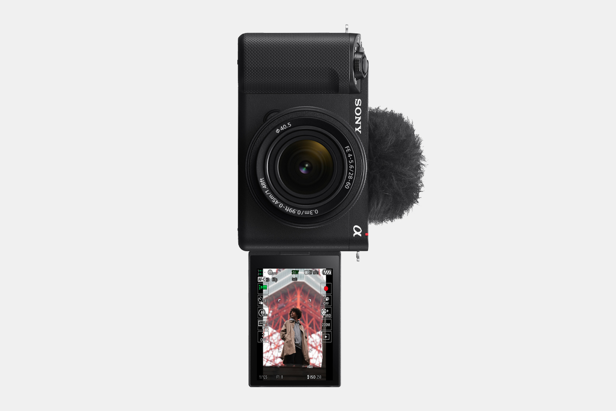 Слика од фотоапаратот ZV-E1, со LCD-екран кој е завртен нанапред и на кој има слика од маж која се прикажува со вертикален приказ на информации